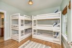 The fourth bedroom has two sets of twin triple bunk beds 